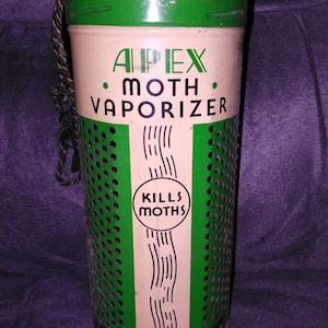 May include: Vintage Apex Moth Vaporizer, a cylindrical metal container with a green and white color scheme. The text "Apex Moth Vaporizer" is displayed prominently. The container has a perforated design and a rope handle. The text "Kills Moths" is also visible.