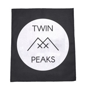 May include: Black and white patch with a white circle containing the text "Twin Peaks" and a stylised image of two mountains with an X in the middle.