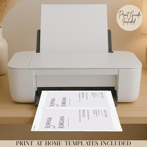 May include: A white printer printing wedding invitation templates. The invitations feature the names "Sophia and Jordan" and the date "05.15.20XX". The image includes the text "Print at Home Templates Included" and "Print Guide Included".