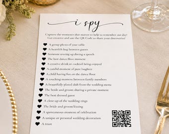 May include: A white rectangular wedding I Spy game card with black text and heart icons. The card lists photo prompts and includes a QR code. The text reads: i spy, Capture the moments that matter to us, and a list of 15 photo tasks to complete.
