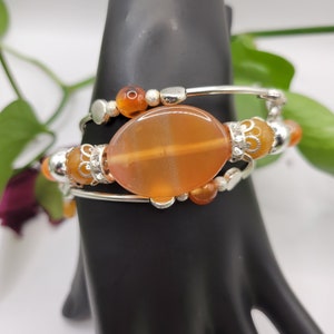 Oval Centerpiece Carnelian bracelet with multiple rings.