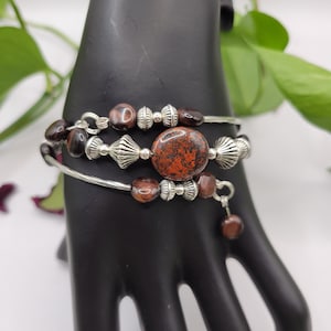 Centerpiece Red Jasper bracelet with multiple rings.