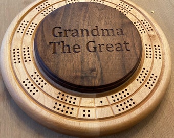 May include: A wooden cribbage board with a walnut centre piece that says "Grandma The Great".