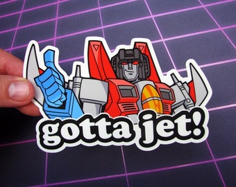 May include: A red, white, and blue cartoon robot with a thumbs up and the text "gotta jet!"