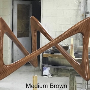 May include: Two wooden pieces of furniture in a medium brown color, shaped like a cross, with a glossy finish.