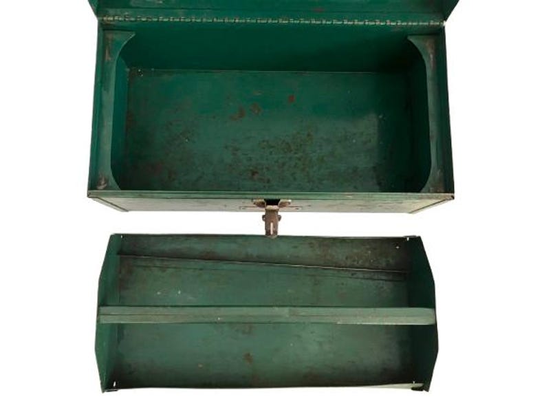 May include: A vintage green metal toolbox with two compartments. The top compartment is open and the bottom compartment has a shelf.