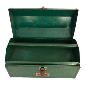 May include: Green metal toolbox with two compartments and a latch. The toolbox has a red and white label that says "P.I.K."