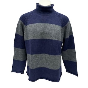 May include: A blue and gray striped turtleneck sweater. The sweater has a ribbed texture and a relaxed fit.