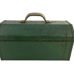 May include: A vintage green metal toolbox with a metal handle. The toolbox has a worn, distressed look.