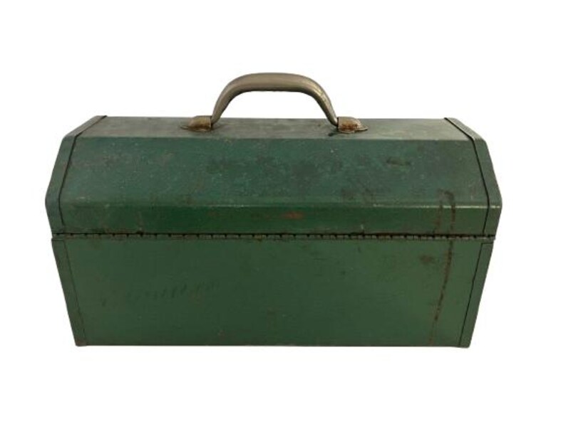 May include: A vintage green metal toolbox with a metal handle. The toolbox has a worn, distressed look.