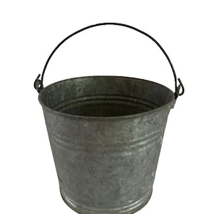 May include: A silver metal bucket with a black metal handle. The bucket has a slightly worn, rustic look.