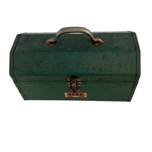 May include: A vintage green metal toolbox with a silver handle and a "PARK" label. The toolbox has a worn, distressed look.