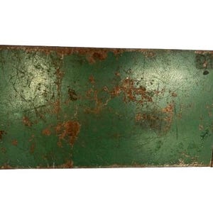 May include: A vintage green metal box with rust and scratches. The box has a rectangular shape and is made of metal. The box is old and has been used for a long time.
