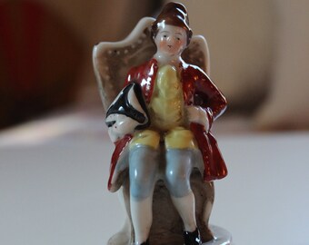 Colonial Porcelain Figurine of Seated Man