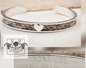 May include: Silver bangle bracelet with a braided horsehair band and a small heart charm. The bracelet is engraved with "KONA JOE June 23rd, 1999 - Nov. 14th, 2023".