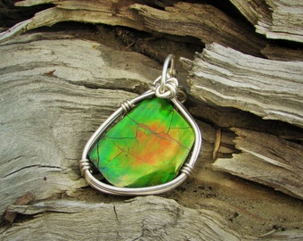 ammolite gemstone pendant wrapped in sterling silver wire.