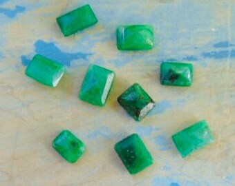 lot of nine loose emerald gemstones