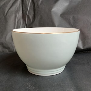 May include: A white ceramic mug with a black handle and the text "But First, Coffee" in a bold, black font. The mug is likely 310-425 ml in size, ideal for a morning beverage. The design is simple and modern.