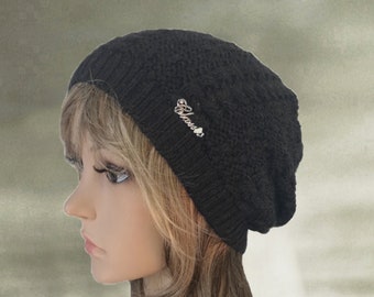 May include: A black knit beanie with a small silver charm that says "Guess" on it.
