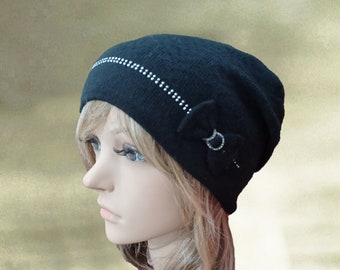 May include: Black knit beanie with a rhinestone trim and a black bow on the side.