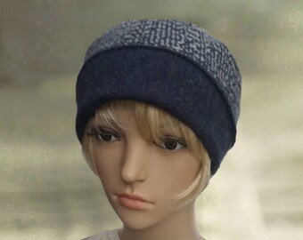 May include: A blue and gray knit beanie hat with a folded brim. The hat is made of a soft, comfortable material and has a simple, stylish design.