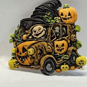 May include: A vintage Halloween decoration featuring a pumpkin-shaped car with a witch's hat on top. The car is filled with pumpkins and a grinning ghoul is driving.