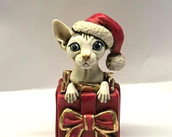 Neil Eyre Artist EyreDesigns Christmas Santa Sphynx Hairless Kitty Cat Kitten Sphinx Present Red Bow Hat Gold Leaf Made USA Tree Ornament