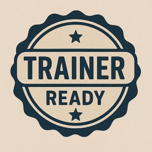 May include: A navy blue and beige circular badge with the words "TRAINER READY" in a bold, sans-serif font. The badge has a scalloped edge and two small stars, one above "TRAINER" and one below "READY".