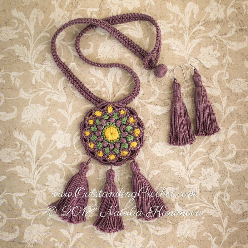 May include: A crocheted necklace with a round, multi-colored mandala pendant and tassel accents. Matching crocheted earrings with tassels are also included. The necklace and earrings are a deep purple color.