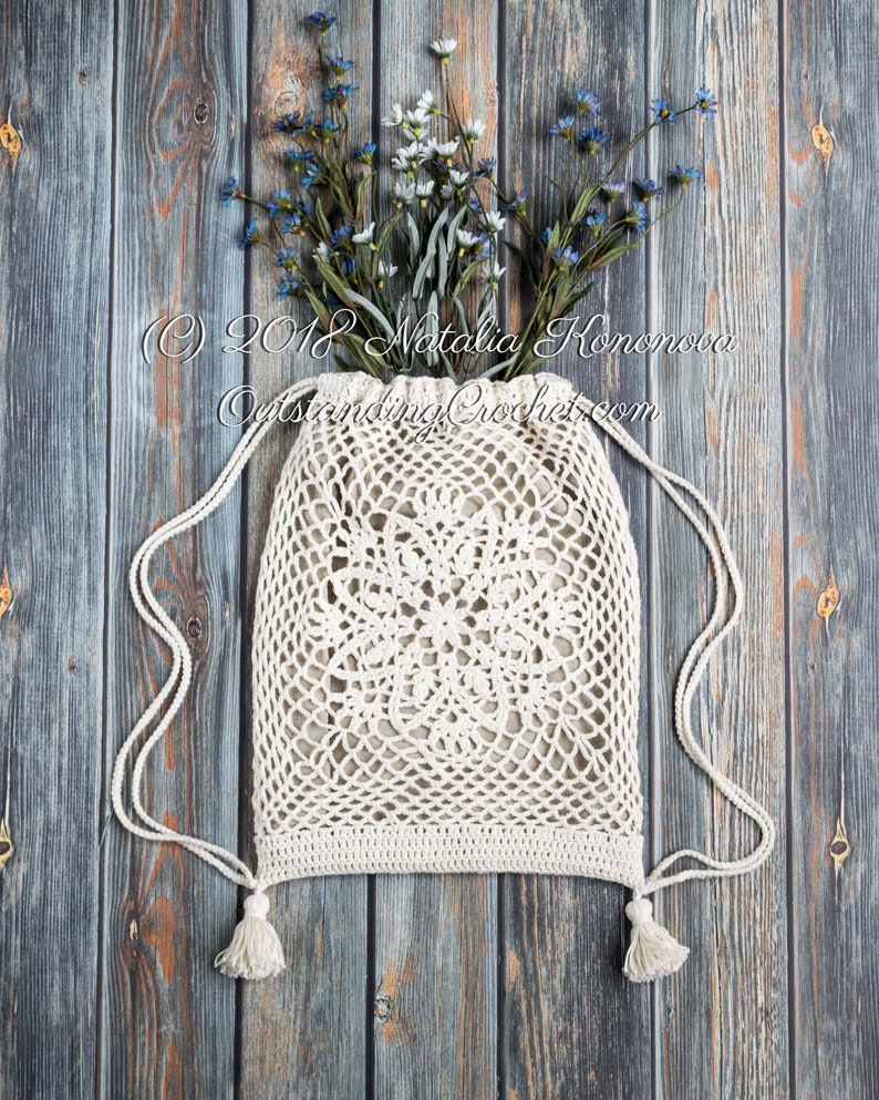 Crochet bag pattern: Lotus lace drawstring backpack with beautiful lace motifs on moth sides and fabric lining, decorated with tassels.