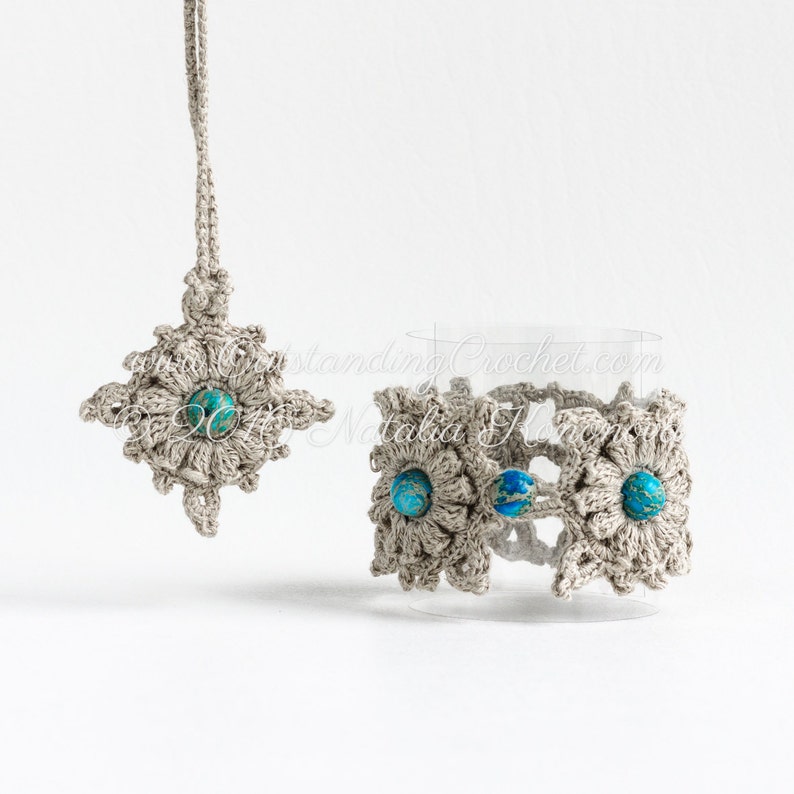 May include: A set of two crocheted flower charms with turquoise beads in the center. The charms are made with beige yarn and are attached to a string. The charms are displayed on a white background.