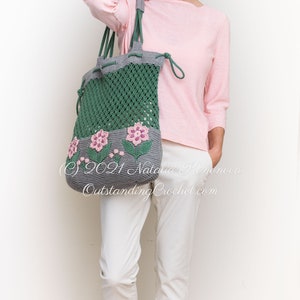 Crochet bag pattern: a shoulder bag with a combination of embossed crochet bottom with 3D flowers and leaves and a net top. Beautiful original multi-corded handles and a drawstring that goes through the top.