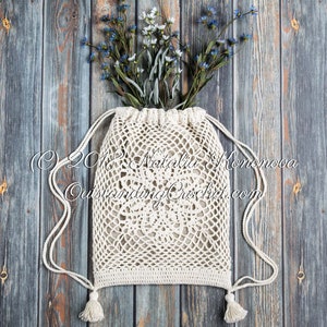 Crochet bag pattern: Lotus lace drawstring backpack with beautiful lace motifs on moth sides and fabric lining, decorated with tassels.