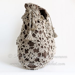 Crochet pattern: Window Frost crochet lace shoulder bag made with joined as you go motifs and solid inner bag. Decorated with a drawstring at the upper edge and tassels.