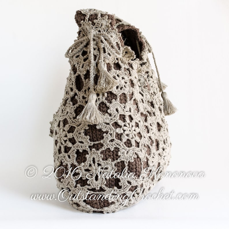Crochet pattern: Window Frost crochet lace shoulder bag made with joined as you go motifs and solid inner bag. Decorated with a drawstring at the upper edge and tassels.