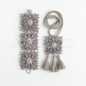 May include: A set of crocheted jewelry featuring a purple and beige color scheme. The set includes a bracelet with three square motifs and a necklace with one square motif and three tassels.