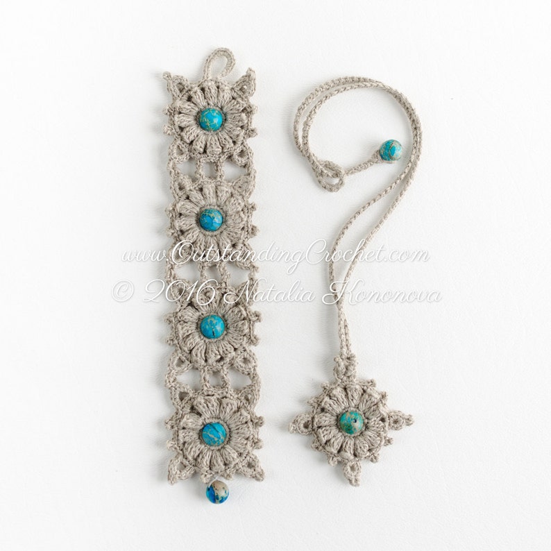 May include: A set of two crocheted necklaces with turquoise beads. The longer necklace has five beads and the shorter necklace has one bead. Both necklaces feature a crocheted flower design.