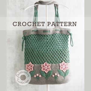 Crochet bag pattern: a shoulder bag with a combination of embossed crochet bottom with 3D flowers and leaves and a net top. Beautiful original multi-corded handles and a drawstring that goes through the top.