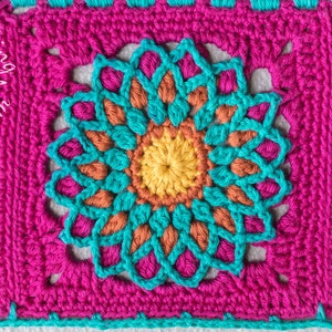 May include: Close-up of a crocheted blanket with a repeating pattern of colorful flowers. The blanket is made with turquoise, orange, yellow, and pink yarn.