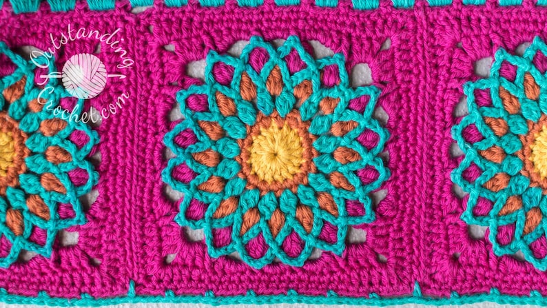 May include: Close-up of a crocheted blanket with a repeating pattern of colorful flowers. The blanket is made with turquoise, orange, yellow, and pink yarn.