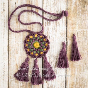 May include: A crocheted necklace with a purple cord and a round, multi-colored crocheted pendant with tassels. Matching purple tassel earrings are also included. The text "www.OutstandingCrochet.com &copy; 2018 Natalia  Konovova" is visible in the image.