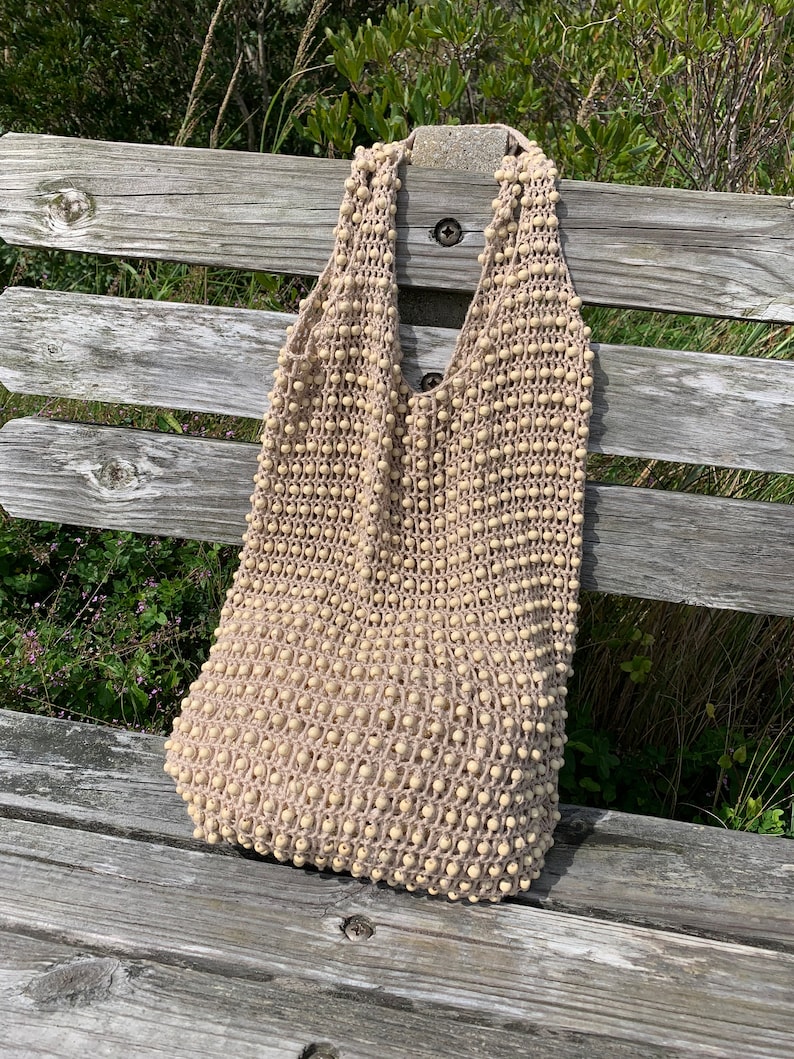 Shoulder bag or beach bag crochet pattern with weaved in wooden beads.