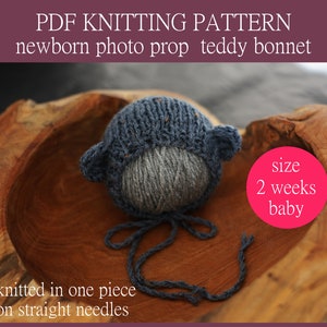 May include: A handmade blue and gray knitted teddy bear bonnet for a newborn baby. The bonnet has small ears and ties, and the text "PDF KNITTING PATTERN" is visible. The size is for a 2-week-old baby.