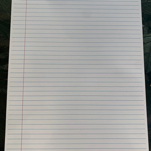 May include: A blank sheet of white lined paper with a red line down the left side.