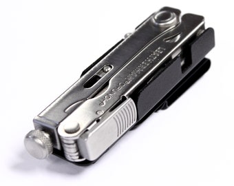 May include: A silver multi-tool with a black sheath. The tool has a variety of blades and tools, including a knife, a saw, a screwdriver, and a pliers. The tool is labeled "Leatherman" and "Crunch" on the side.