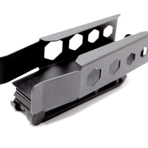 May include: A black metal bracket with a matte finish. The bracket has a rectangular shape with hexagonal cutouts along the sides. The design includes a sliding mechanism and is likely for mounting or securing an item.