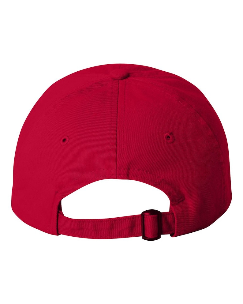 May include: A plain red baseball cap, seen from behind, with a curved peak and a fabric strap with a metal buckle for adjustment. The cap has a classic six-panel design.