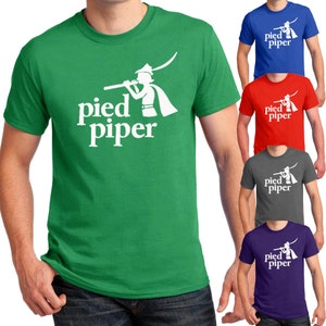 May include: Green t-shirt with a white graphic of a person playing a pipe and the text "pied piper". The shirt is available in other colors: blue, red, gray, and purple.