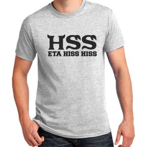 May include: A heather gray t-shirt with black text that reads "HSS ETA HISS HISS".