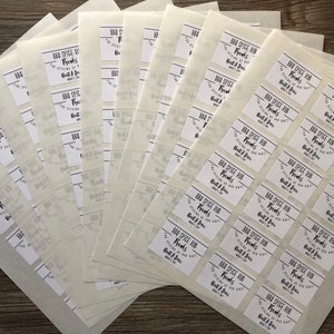 May include: A stack of white sheets of paper with rectangular labels printed with the text "BBQ Spice Rub Thanks for trying our Built & Brew BBQ Spice Rub".
